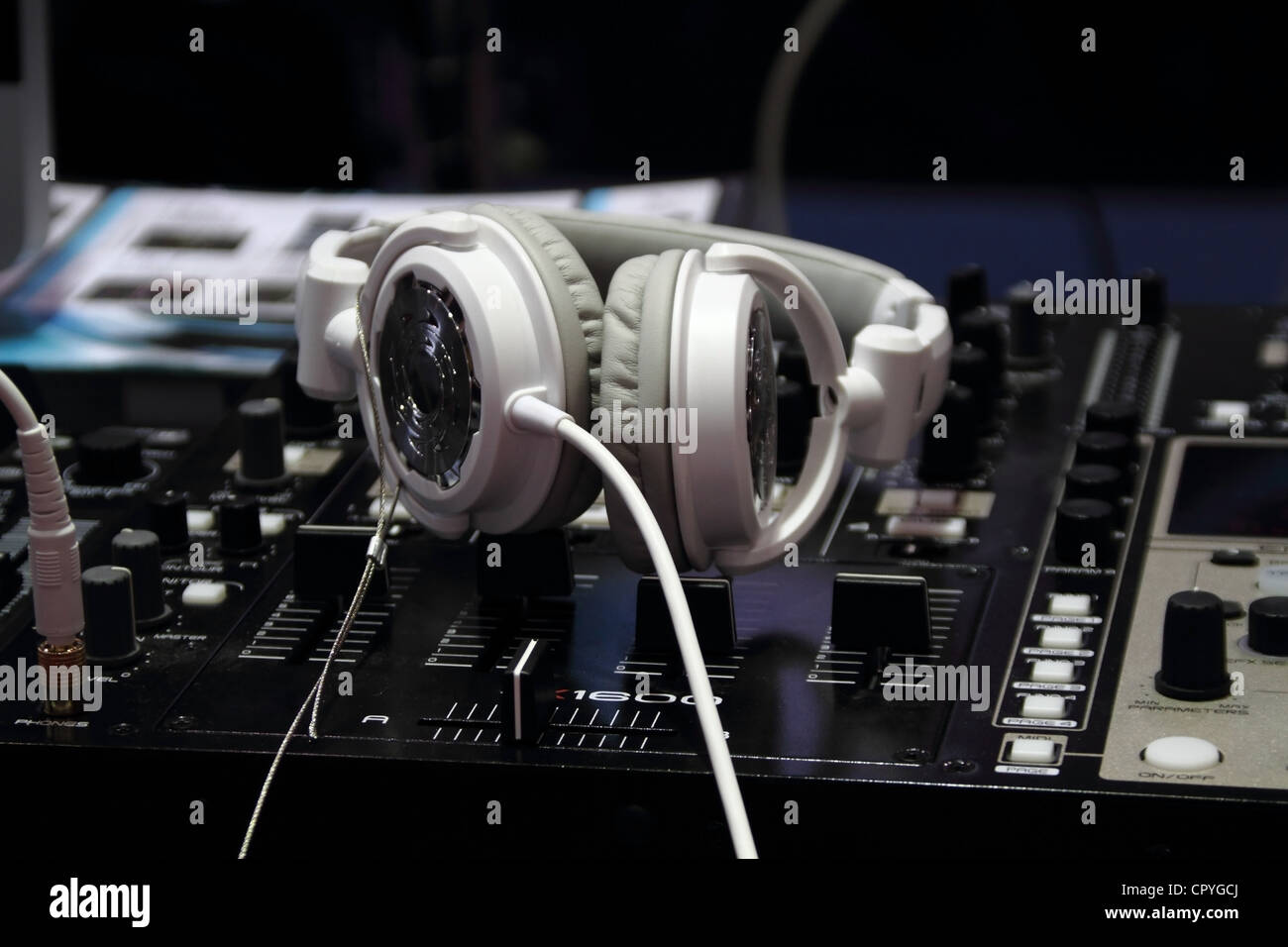 a white headphones on a professional audio mixer Stock Photo Alamy