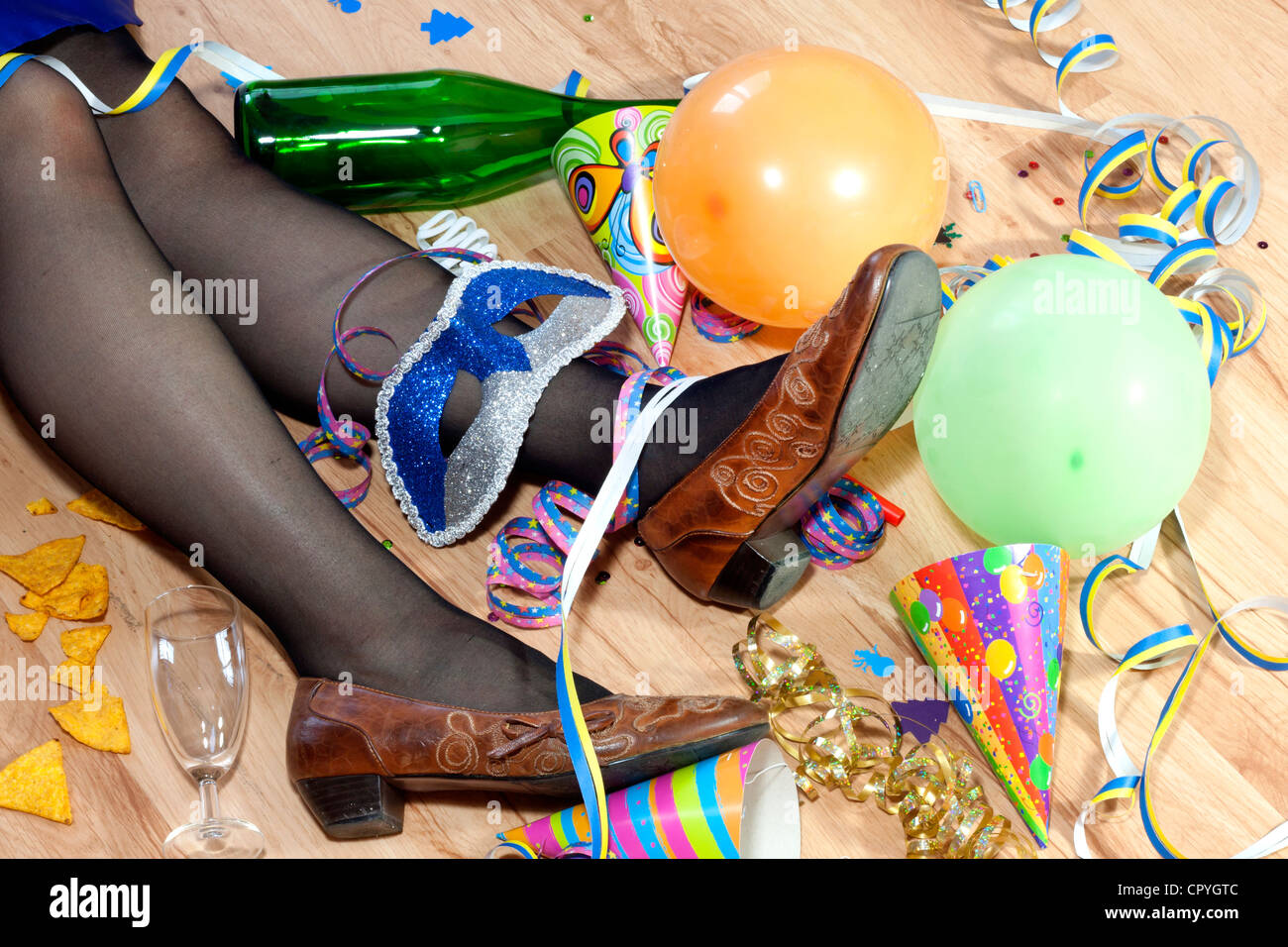 Messy room after cool party next day and sleeping drunk woman Stock Photo