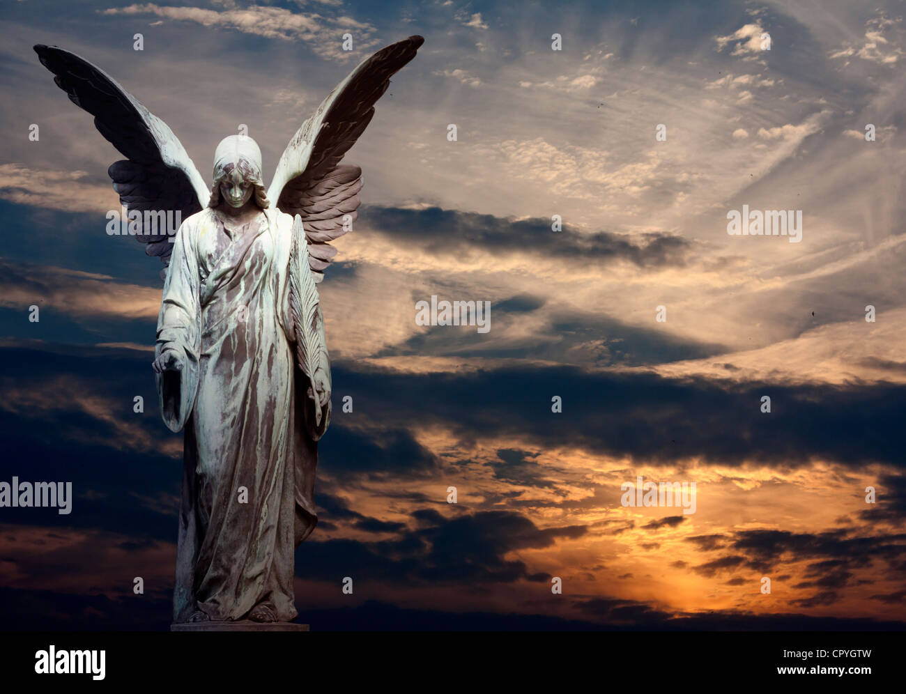 Statue of angel and sunset abstract religion background Stock Photo