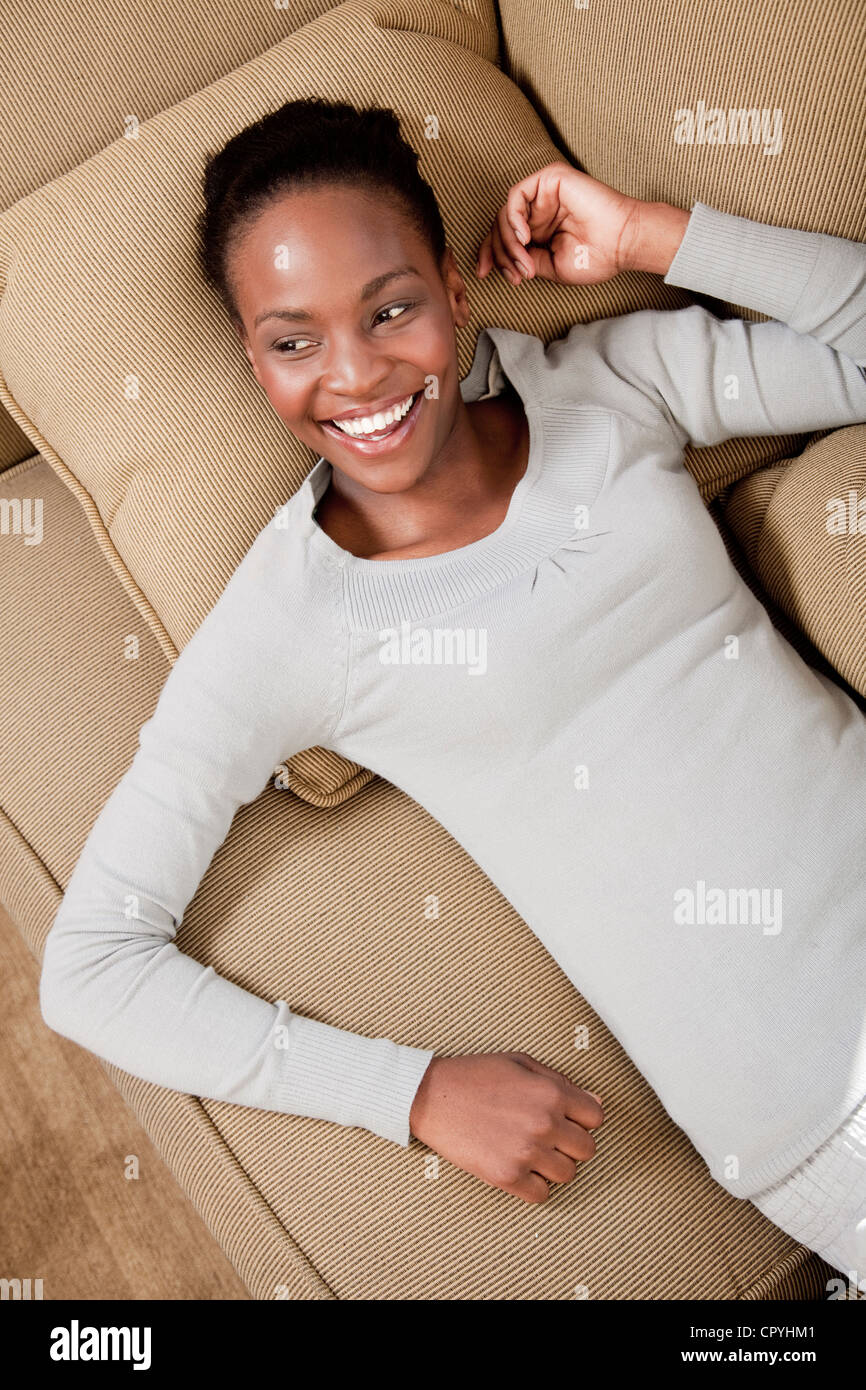 Woman relaxing on couch,  Illovo Family, Johannesburg, South Africa. Stock Photo