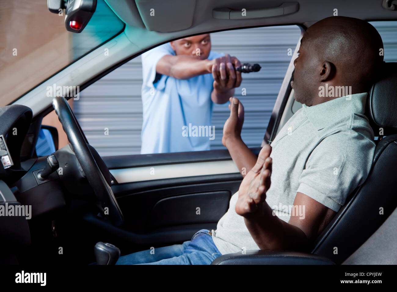 Inside view of a man getting hijacked in his car Stock Photo