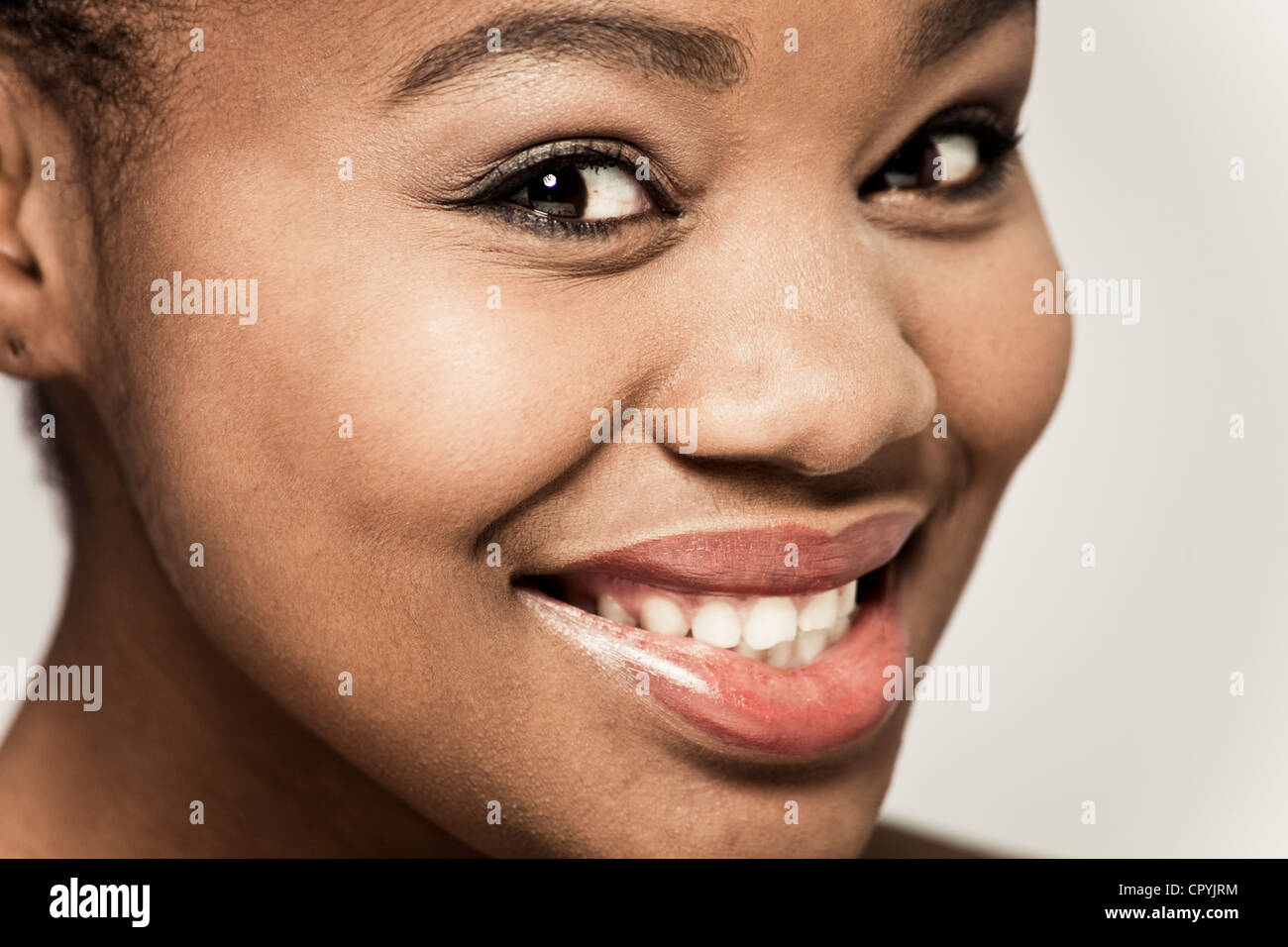 Closeup of young black woman smiling at camera Stock Photo