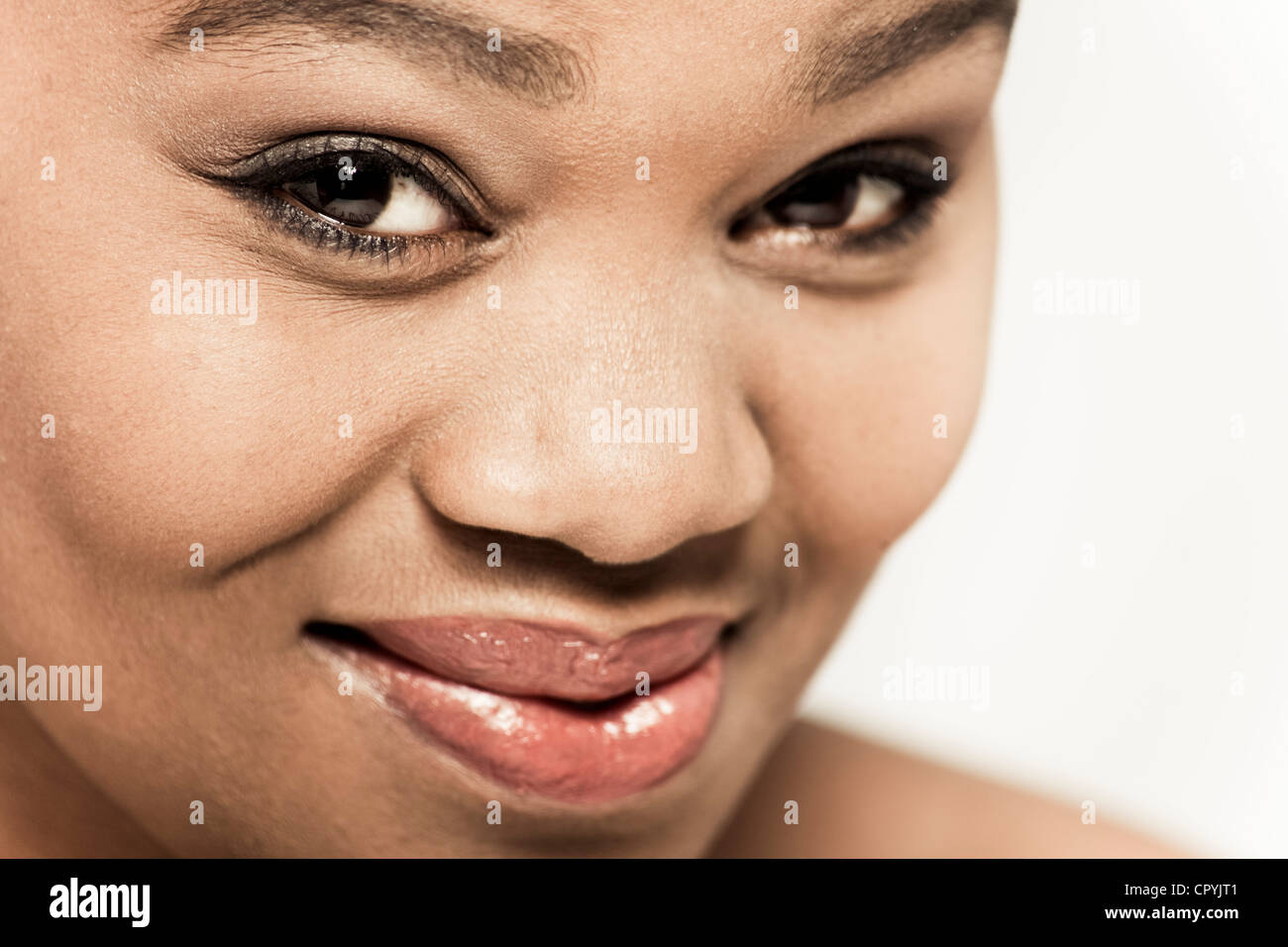 Closeup of young black woman smiling at camera Stock Photo - Alamy
