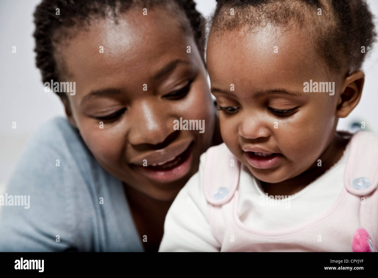 Young black woman playing with her baby daughter Stock Photo - Alamy