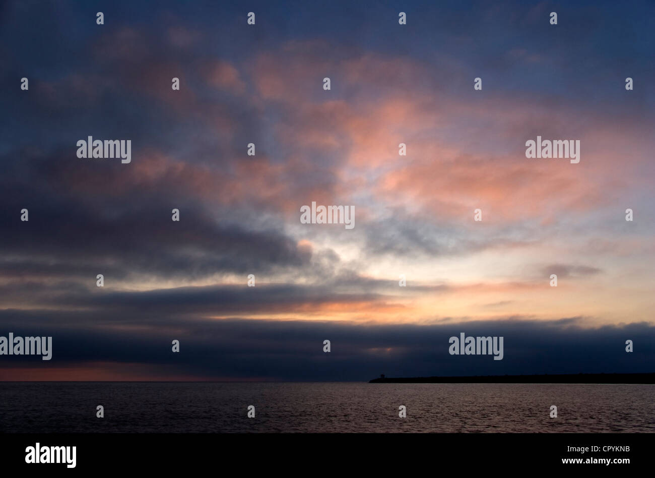 Cloudy Sunset Above the Sea with a Jetty Stock Photo - Alamy