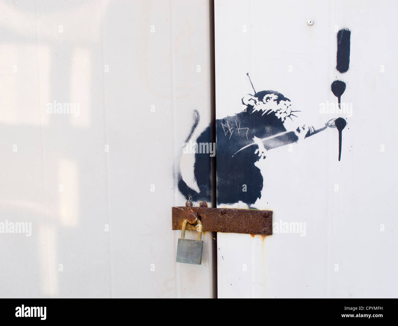 'Banksy' drawing on white metal gates, graffiti Stock Photo