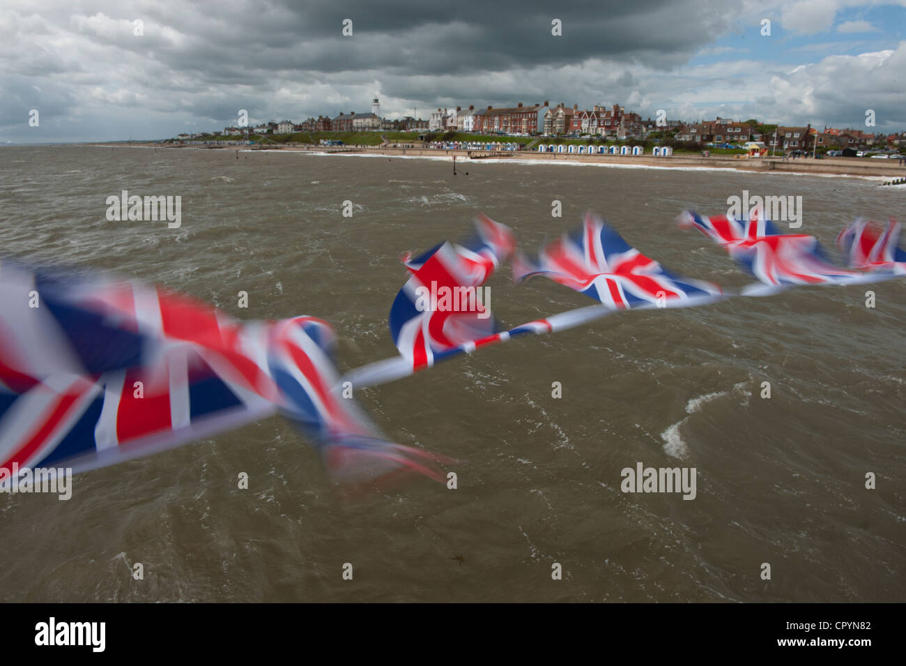 Southwold Beach and Union Jack Flags viewed from the Pier, Southwold, Suffolk, England, UK. 4-June-2012 Union Jack flags flutter Stock Photo