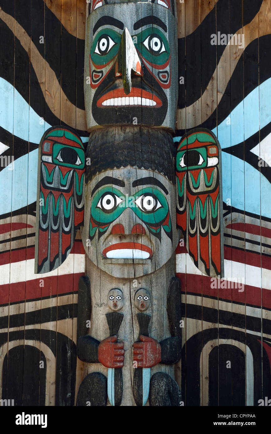 Wooden totem pole, monumental sculpture carved from large tree Stock