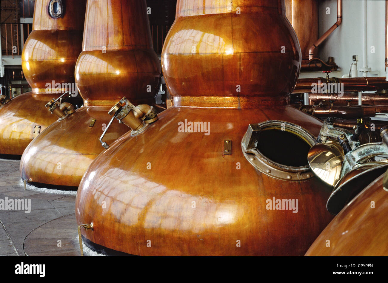 Scottish whiskey distillery three copper pot kiln stills Stock Photo