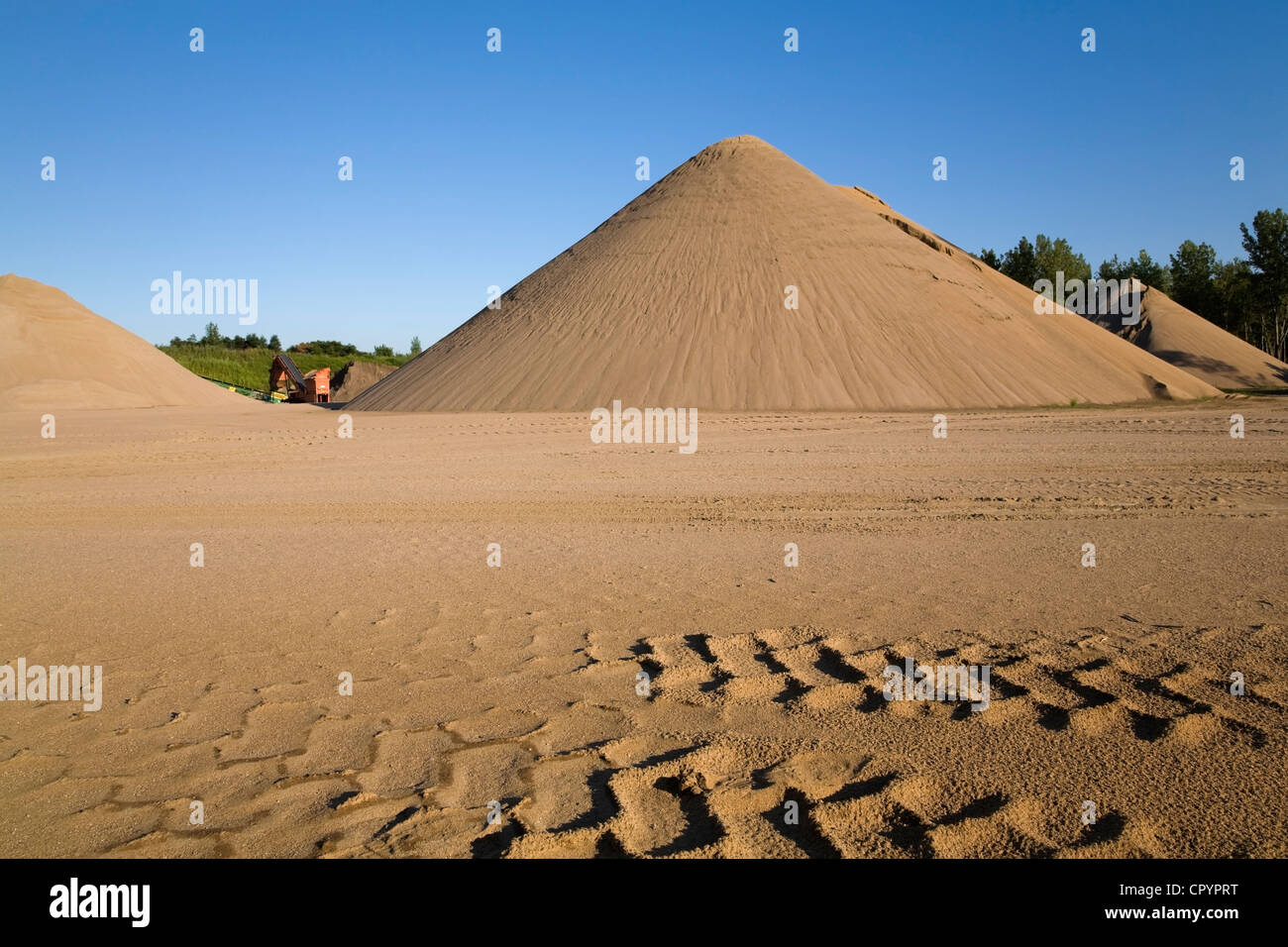 Tire tracks and mounds of sand in a commercial sandpit, Quebec, Canada Stock Photo