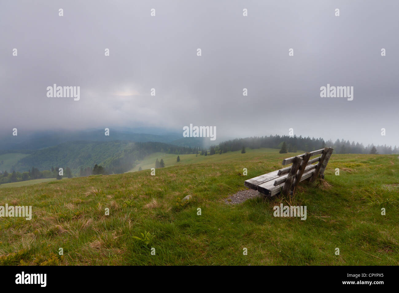 Lonely bench on Herzogenhorn mountain, clouds, southern Black Forest, Baden-Wuerttemberg, Germany, Europe Stock Photo