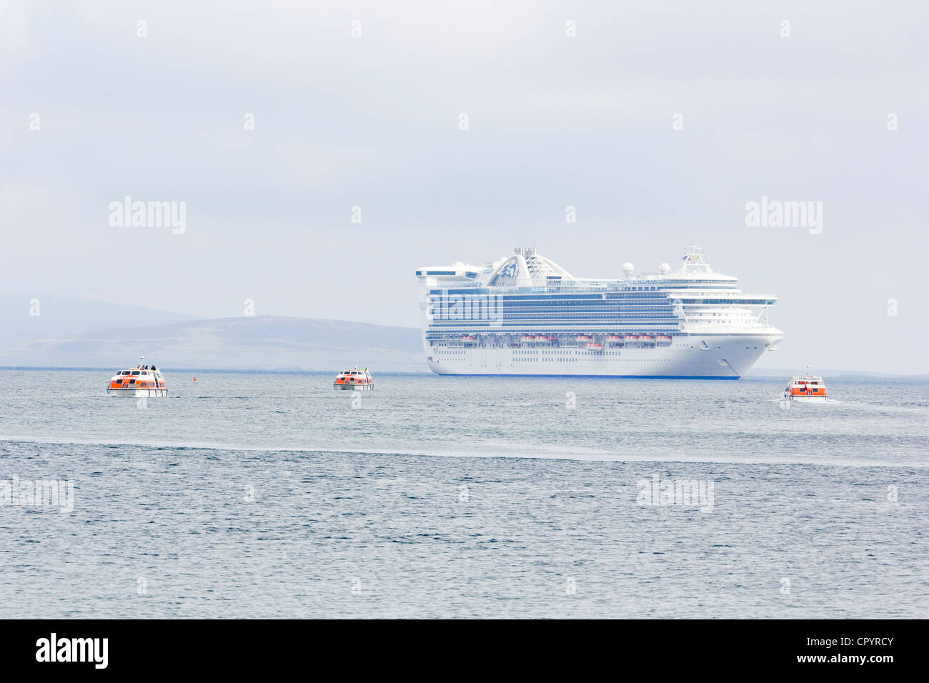 Kirkwall Harbour, Orkney Islands with Caribbean Princess anchored off shore Stock Photo