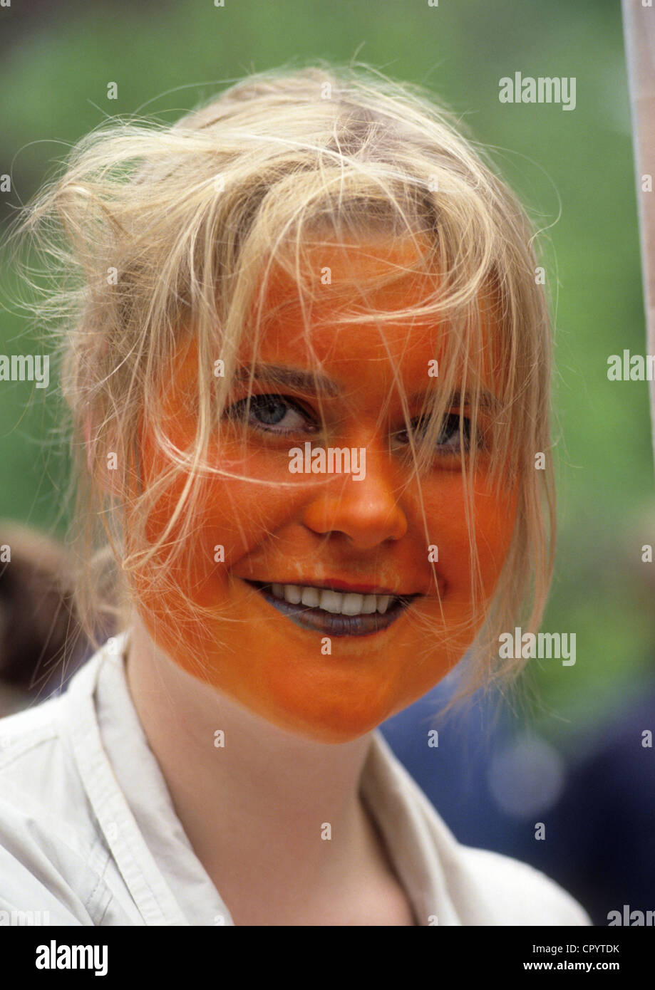 Netherlands, Amsterdam, Dutch woman with her face painted with the national colours Stock Photo