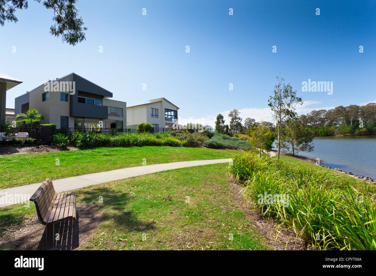Modern two storey Australian house front overlooking a park and river ...