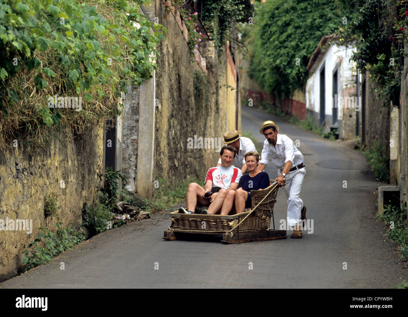 Portugal, Madeira Island, Funchal, playing on a toboggan sledg locally known as Monte Stock Photo