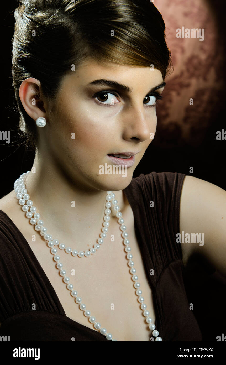 Young woman wearing a pearl necklace and pearl earrings, portrait Stock