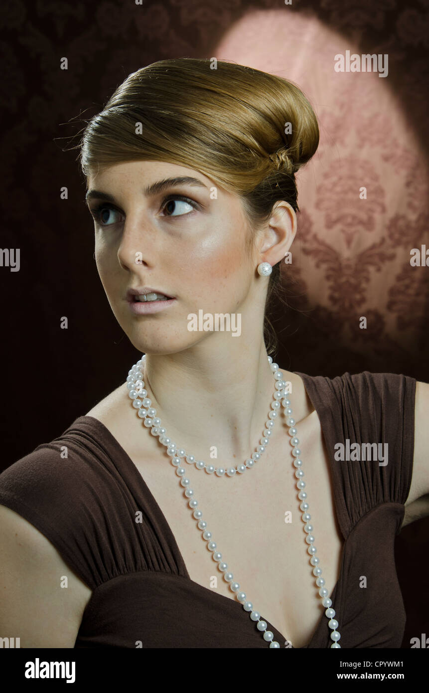 Young woman wearing a pearl necklace and pearl earrings, portrait Stock