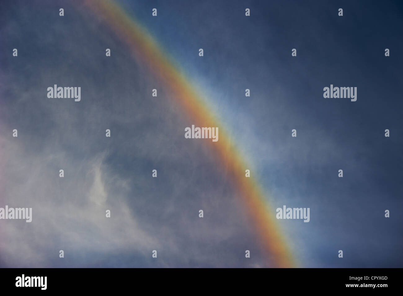 Rainbow against cloudy sky Stock Photo