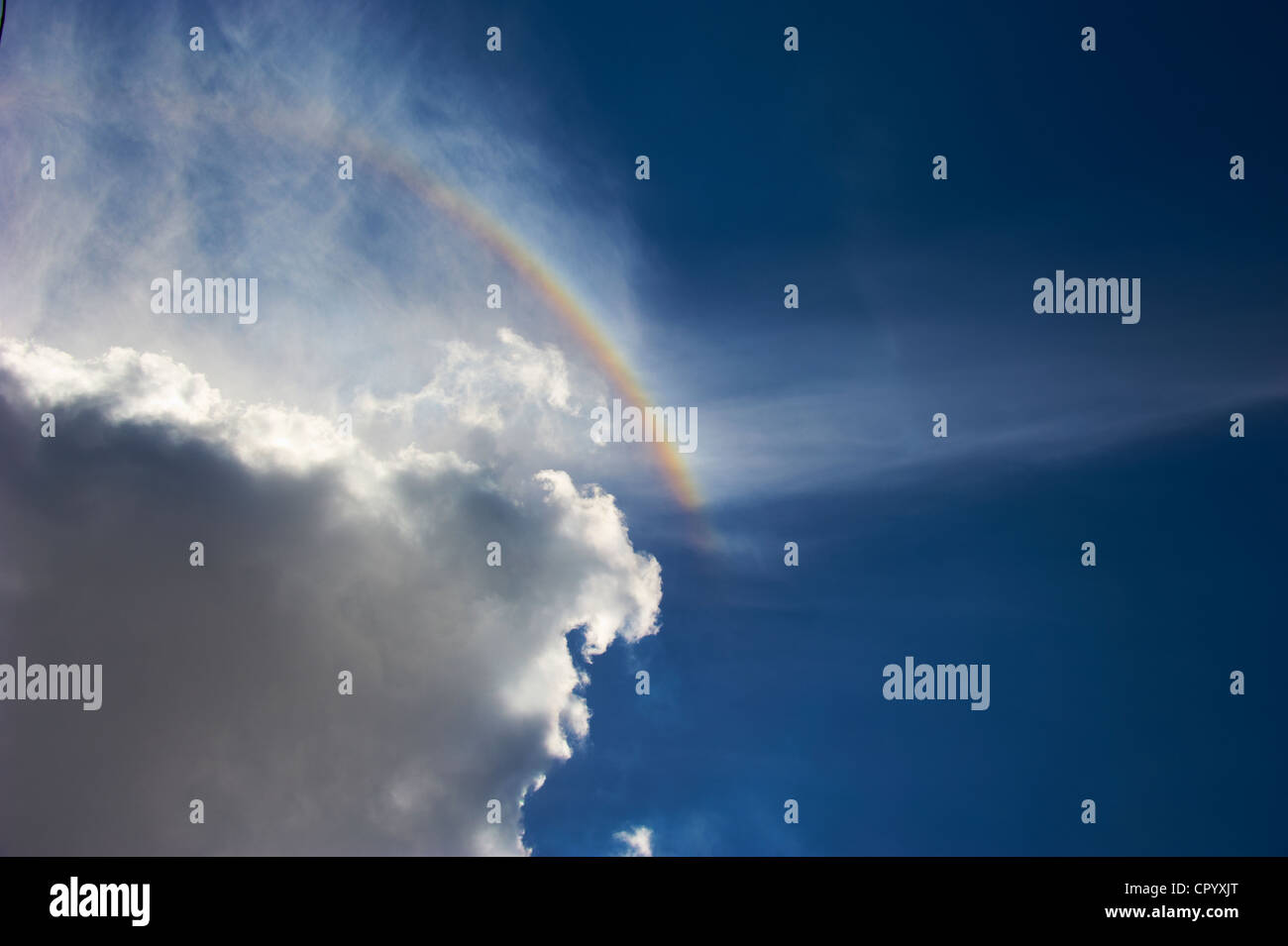 Rainbow against cloudy sky Stock Photo