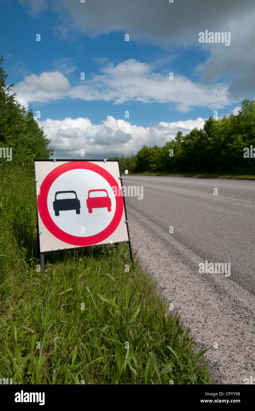 no overtaking warning sign due to loose chippings on newly resurfaced road uk Stock Photo
