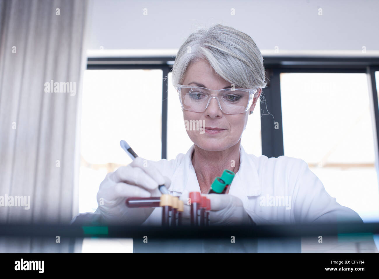 Scientist labeling test tube samples Stock Photo