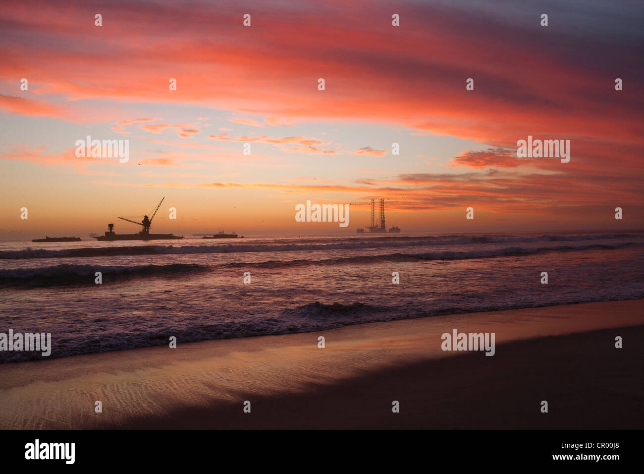 Sunset over submarine at sandy beach Stock Photo