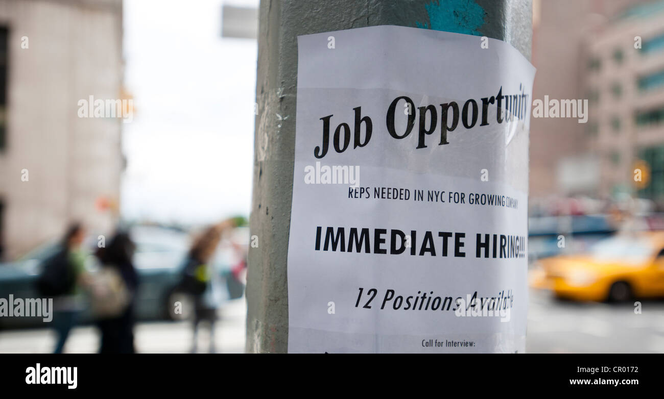A sign on a lamp post in New York advertises immediate hiring and job opportunities Stock Photo