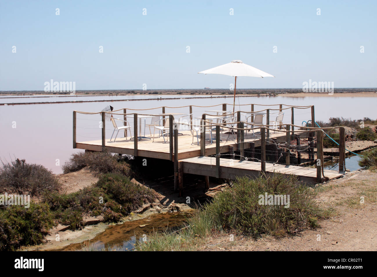 Decking with table and chairs at the Saint Martin oyster farm and restaurant Gruissan Languedoc-Roussillon France Stock Photo
