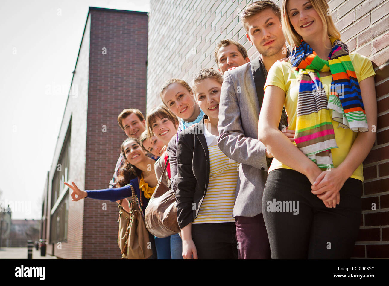 Friends posing together on city street Stock Photo - Alamy