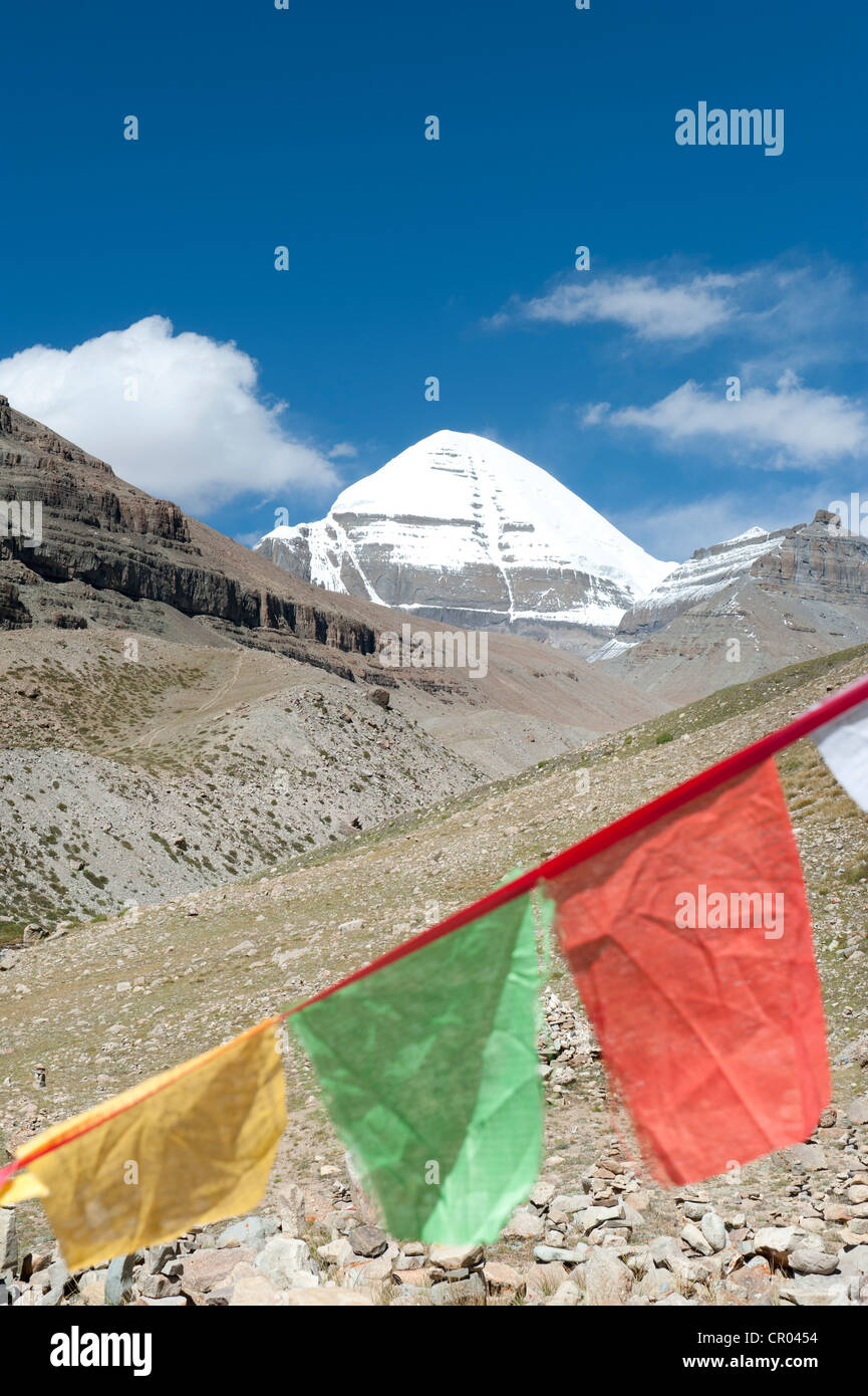 Tibetan Buddhism, colorful prayer flag, snow-capped sacred Mount Kailash, Gang Rinpoche, south side with channel, pilgrim road Stock Photo