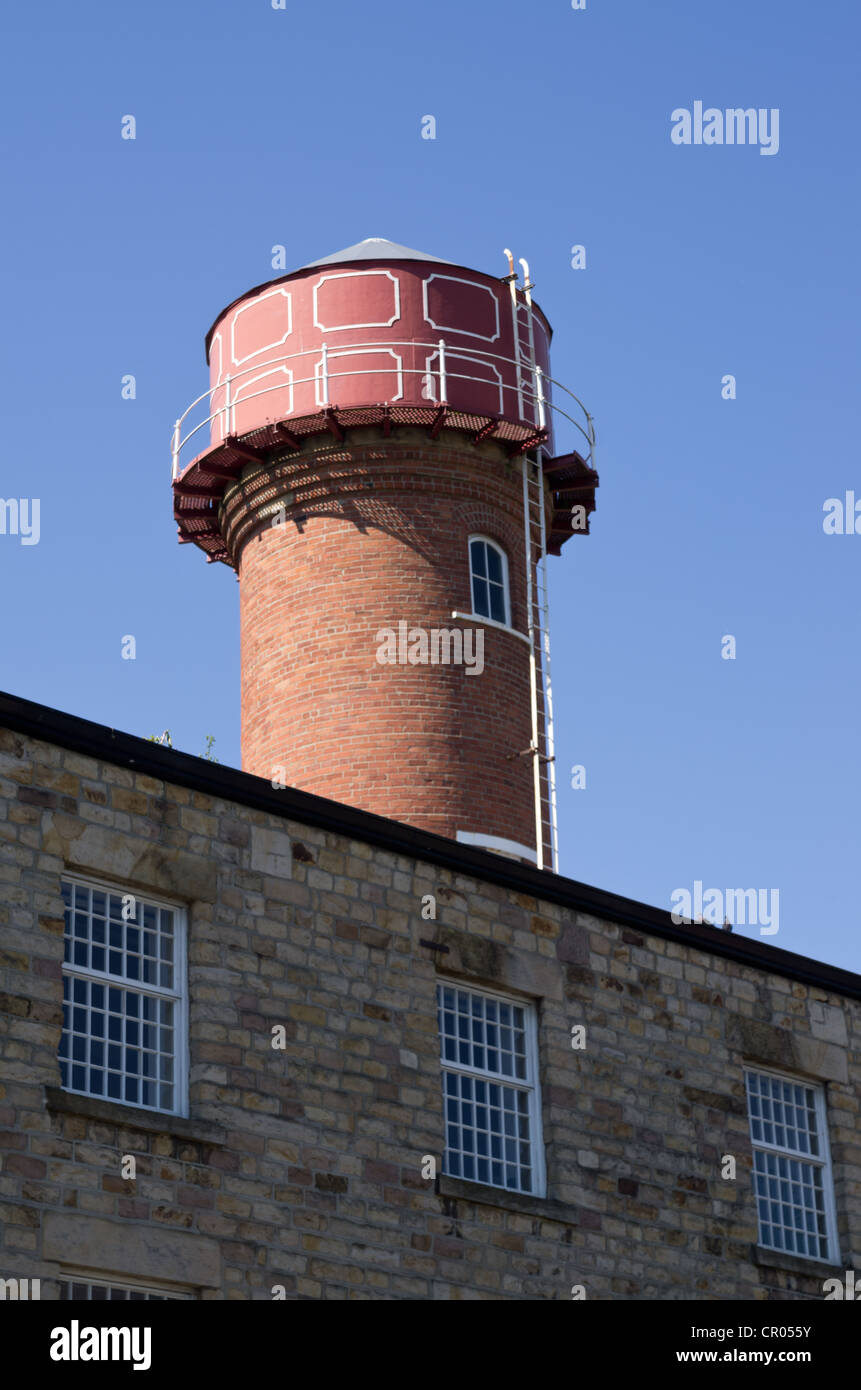 Circular cast iron water tower on brick base, old mill Moor Lane