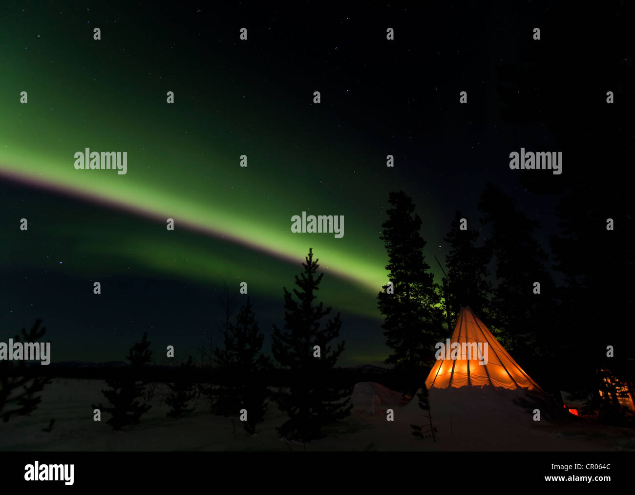 Illuminated teepee, tipi, tepee, northern polar lights, Aurora borealis, green, near Whitehorse, Yukon Territory, Canada Stock Photo