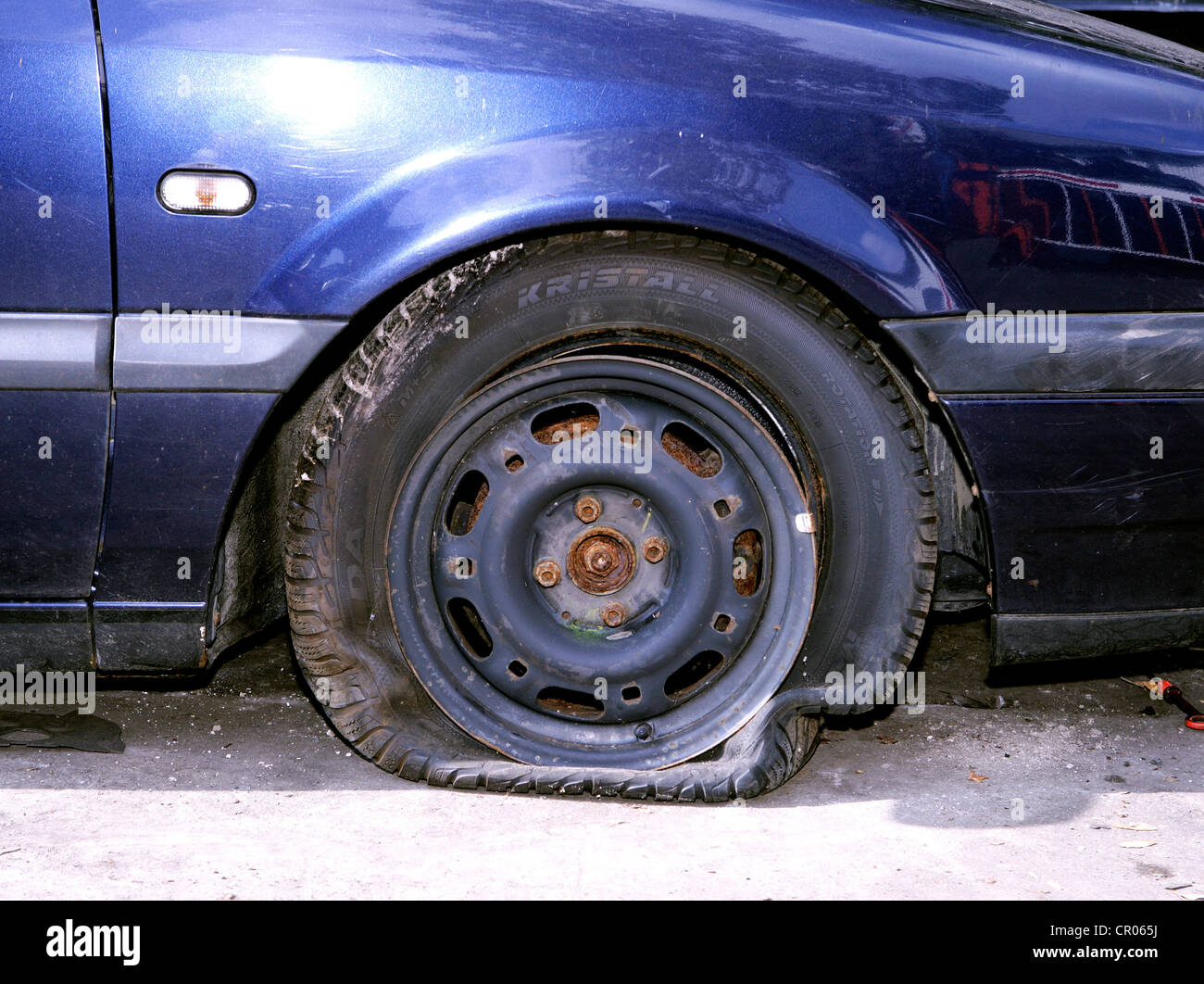 Flat tyre on a car involved in an accident Stock Photo