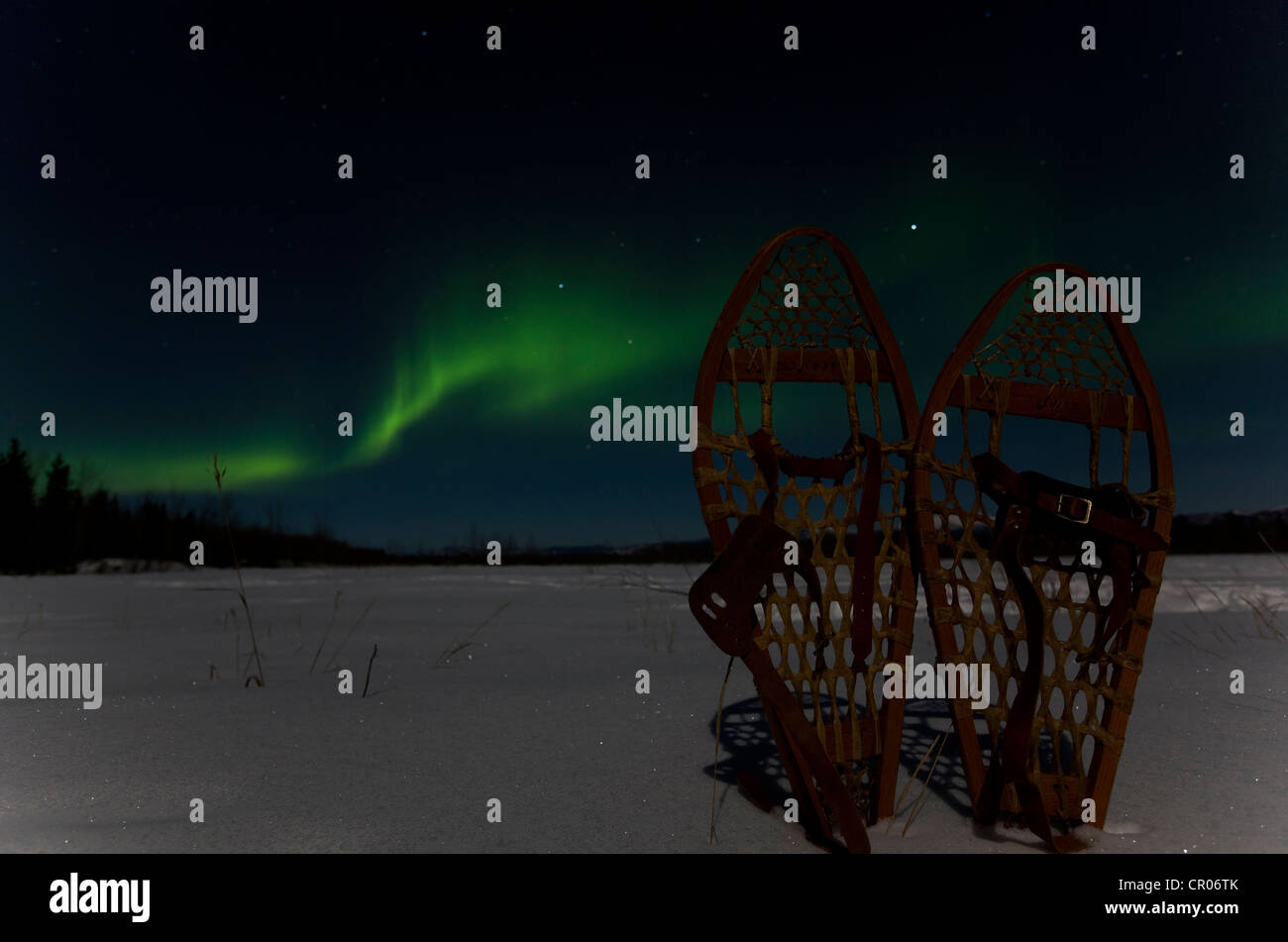 Silhouette of traditional wooden snow shoes, northern polar lights (Aurora borealis), curtains, green, near Whitehorse Stock Photo