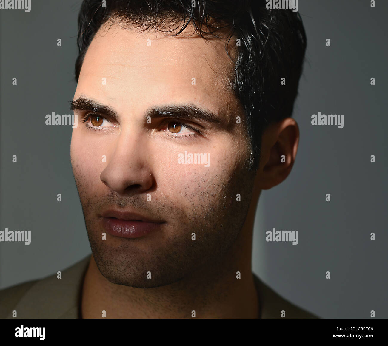 Young man lit by sunlight, portrait Stock Photo - Alamy