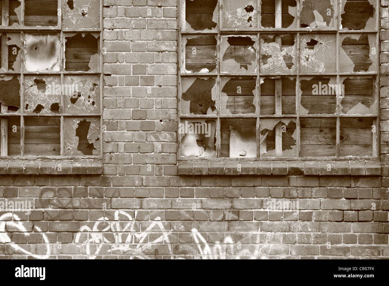 part of a derelict building with graffiti on the wall and broken windows Stock Photo