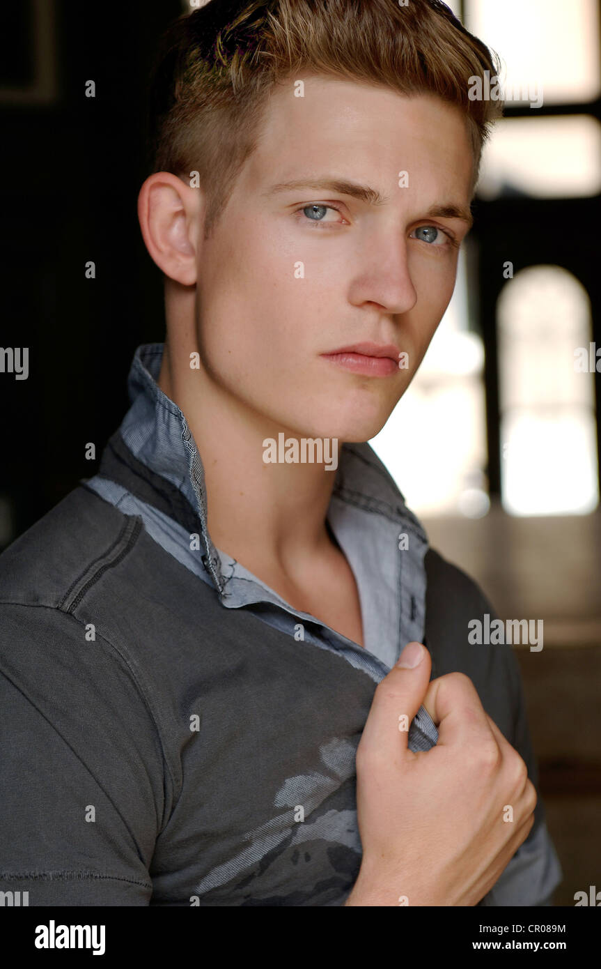 20yearold man, dressed casually, in corridor, portrait Stock Photo