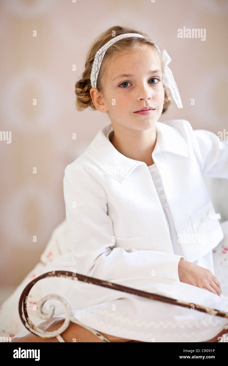 Smiling girl sitting in chair Stock Photo - Alamy