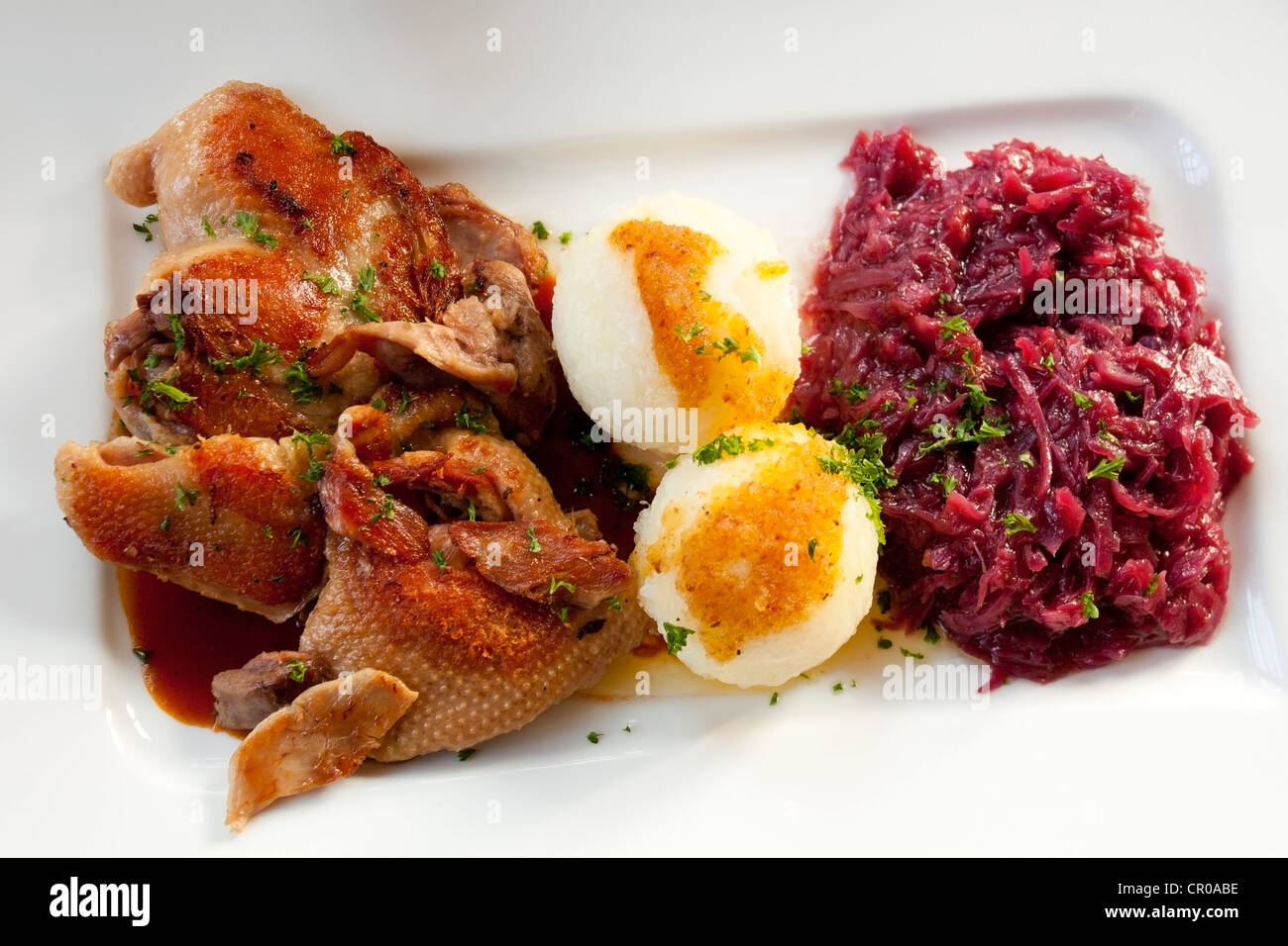 Half a roast duck with potato dumplings and red cabbage Stock Photo