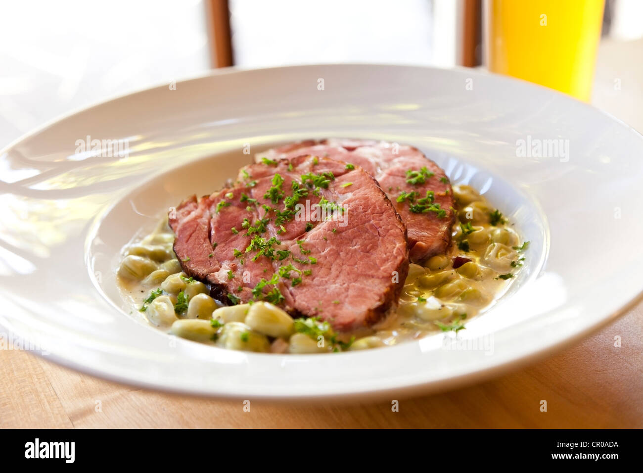 Gammon, smoked pork, with broad beans Stock Photo Alamy