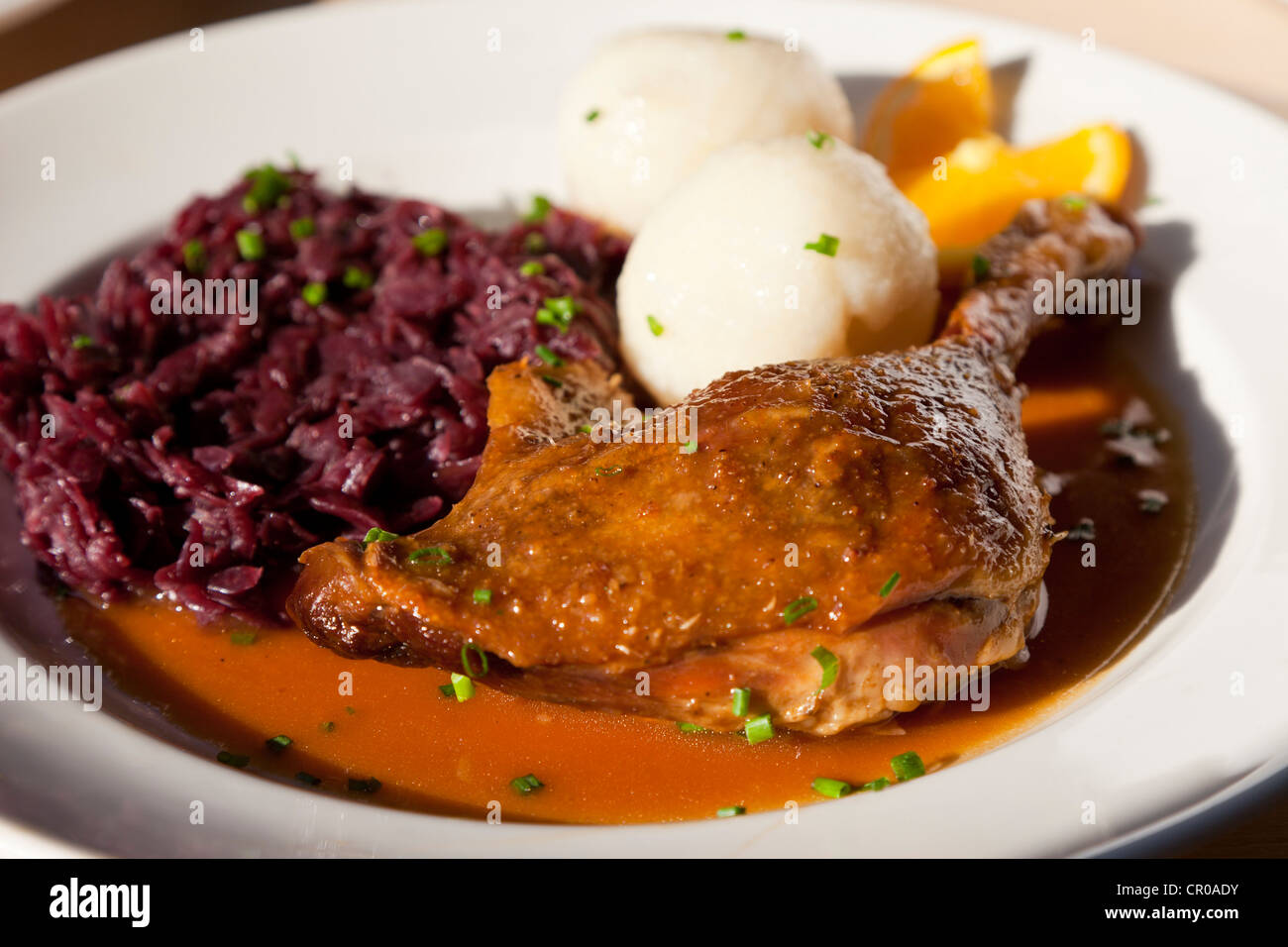 Duck leg with red cabbage and potato dumplings Stock Photo Alamy