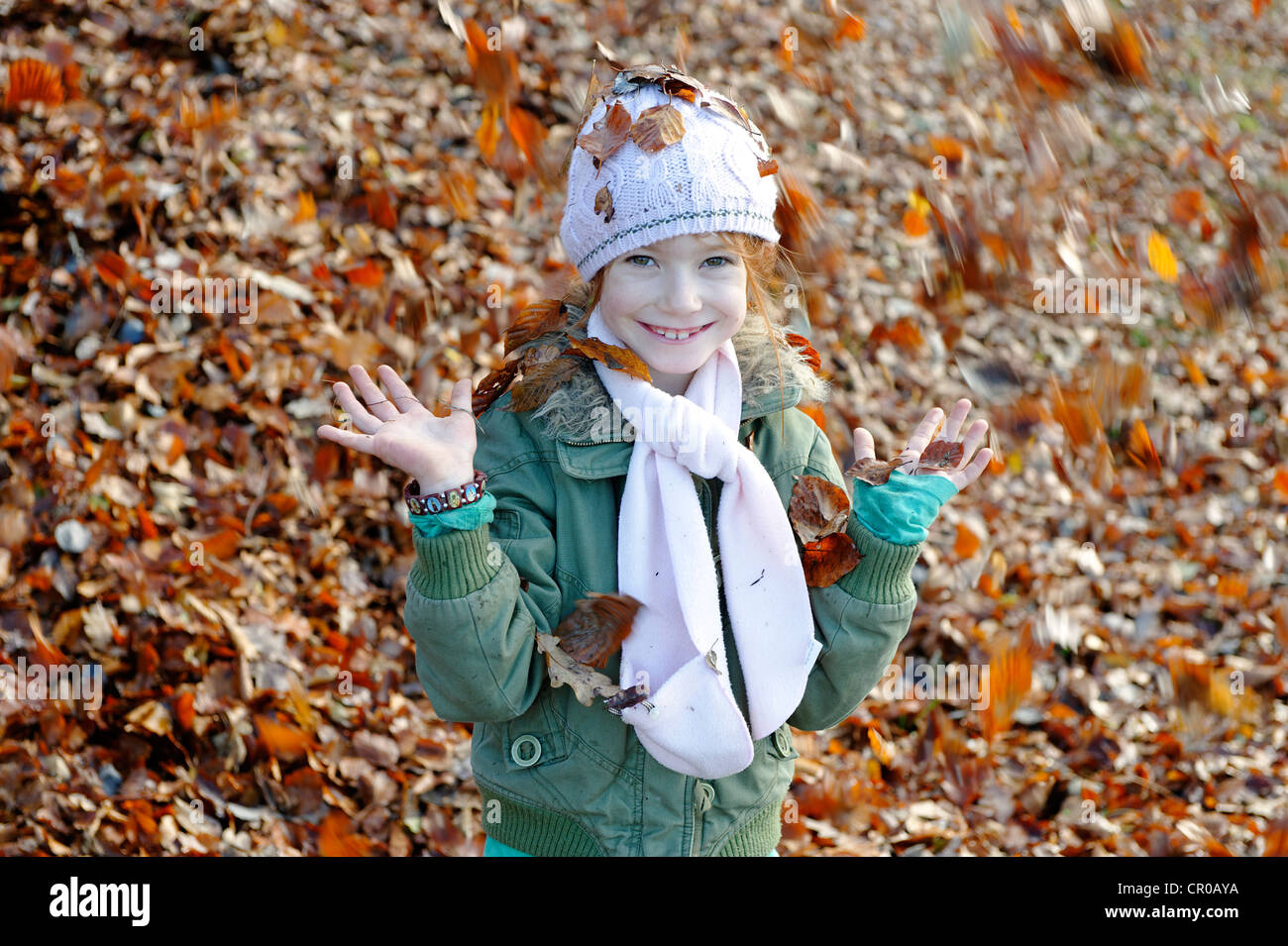 Girl playing with leaves in autumn Stock Photo - Alamy