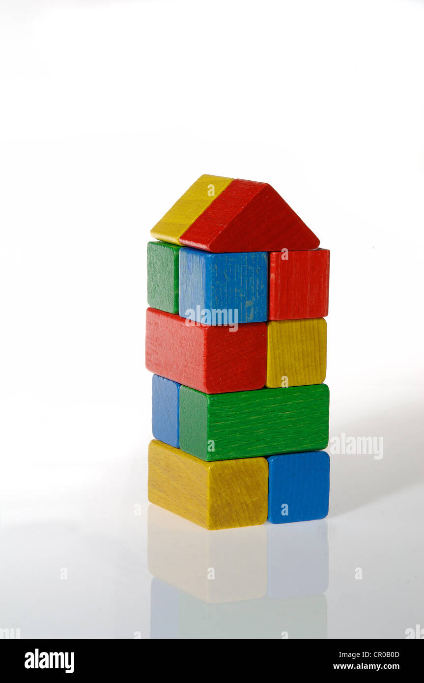 Colourful building blocks assembled in the shape of a tower Stock Photo