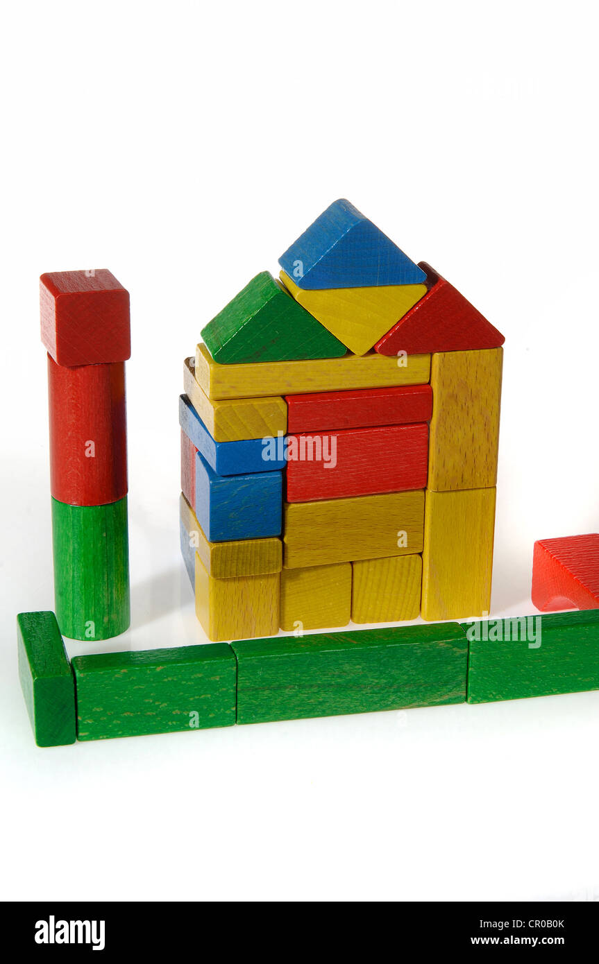 Colourful building blocks assembled in the shape of a house Stock Photo