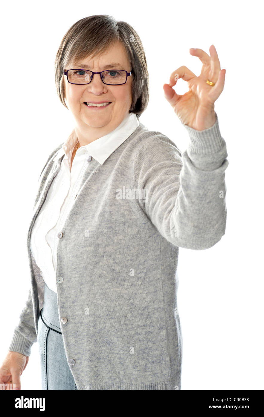 Old lady showing excellent gesture against white background Stock Photo ...
