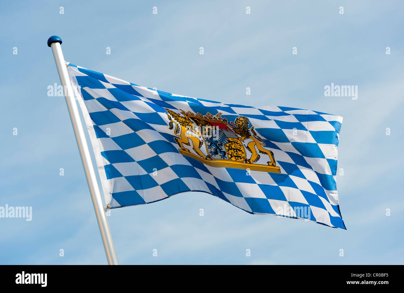 Blue and white flag with the coat of arms of the Free State of Bavaria is blowing in the wind Stock Photo