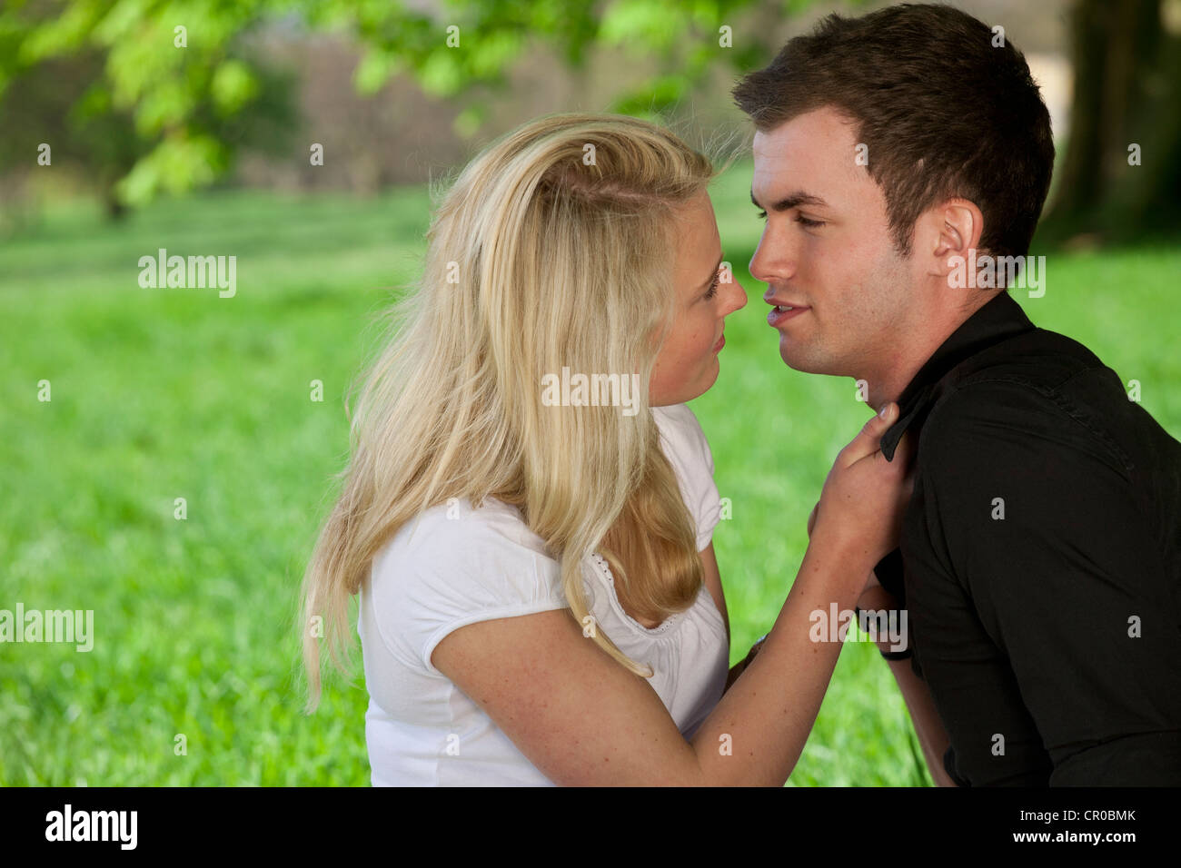 Young couple getting close in a park, spring Stock Photo