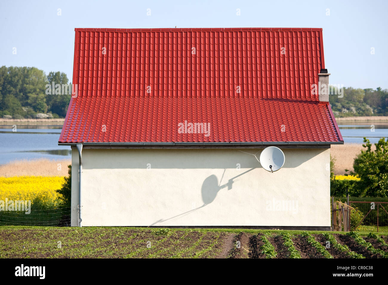 Small house without windows, with a satellite dish on lake Spyker See, Ruegen, Rugia, Mecklenburg-Western Pomerania Stock Photo