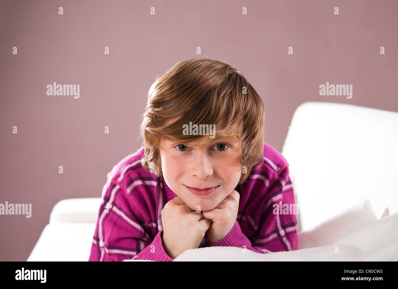 Smiling boy lying on a couch Stock Photo