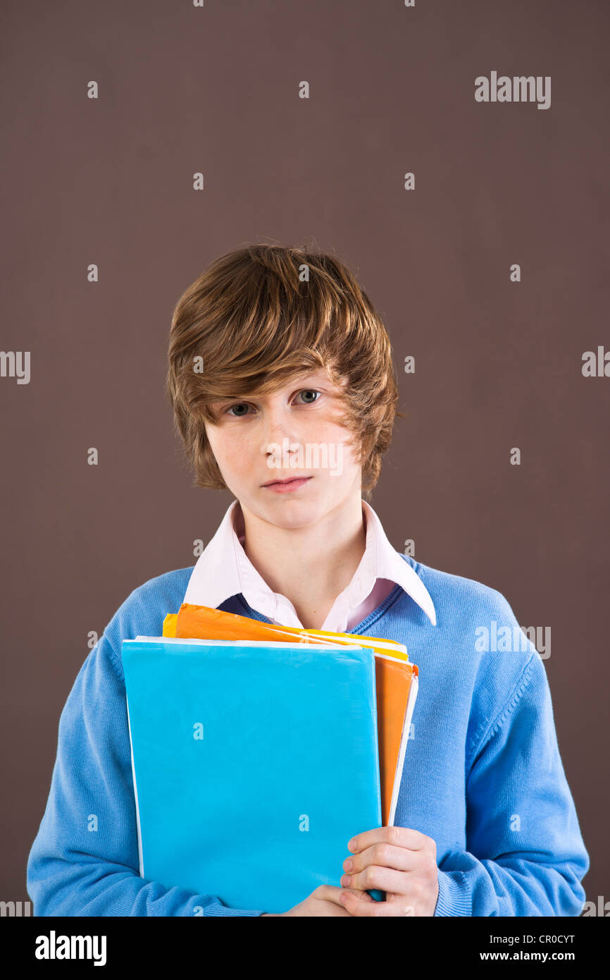 Boy holding school books Stock Photo - Alamy